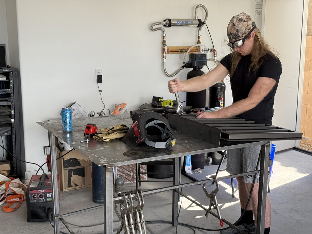 Founder fixing a custom metal gate in the workshop